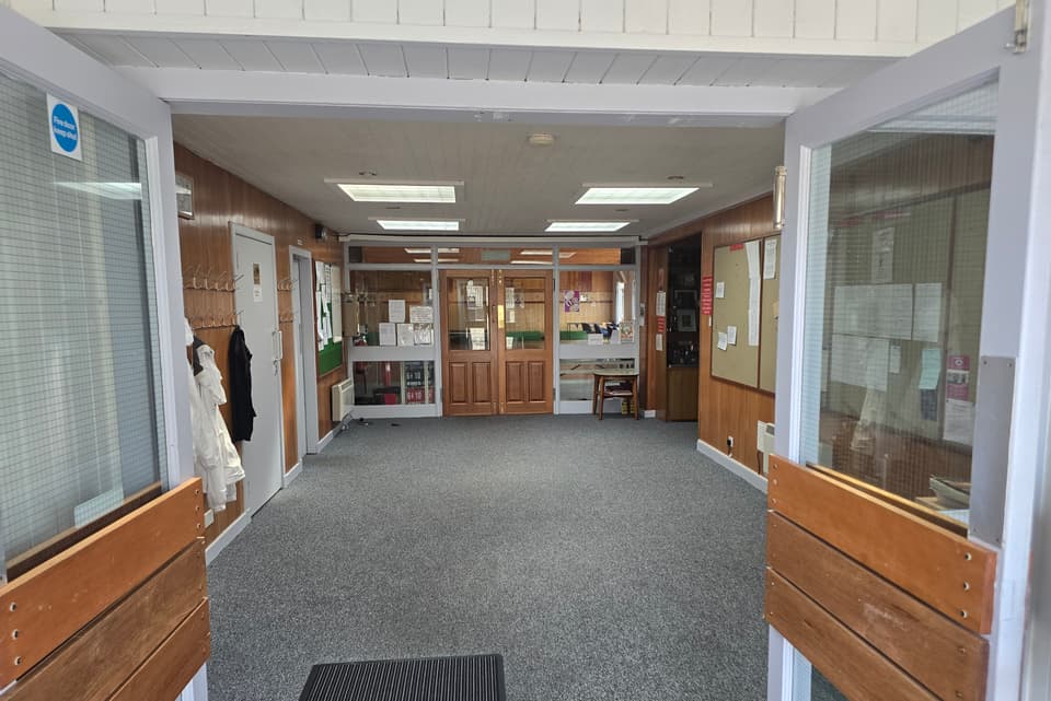 Entrance foyer with noticeboards and trophy cabinet